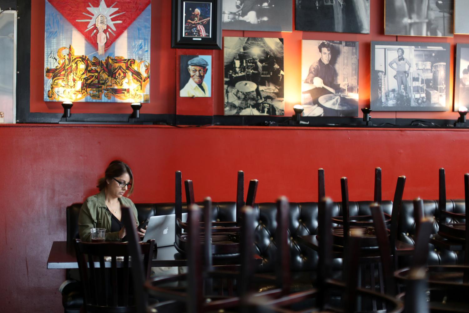 Susan Upton, 53, works on her computer at her family restaurant Mambos, which is being forced to close after 32 years, due to the global outbreak of the coronavirus disease (COVID-19), in Glendale, California, U.S., March 18, 2020.  REUTERS/Lucy Nicholson