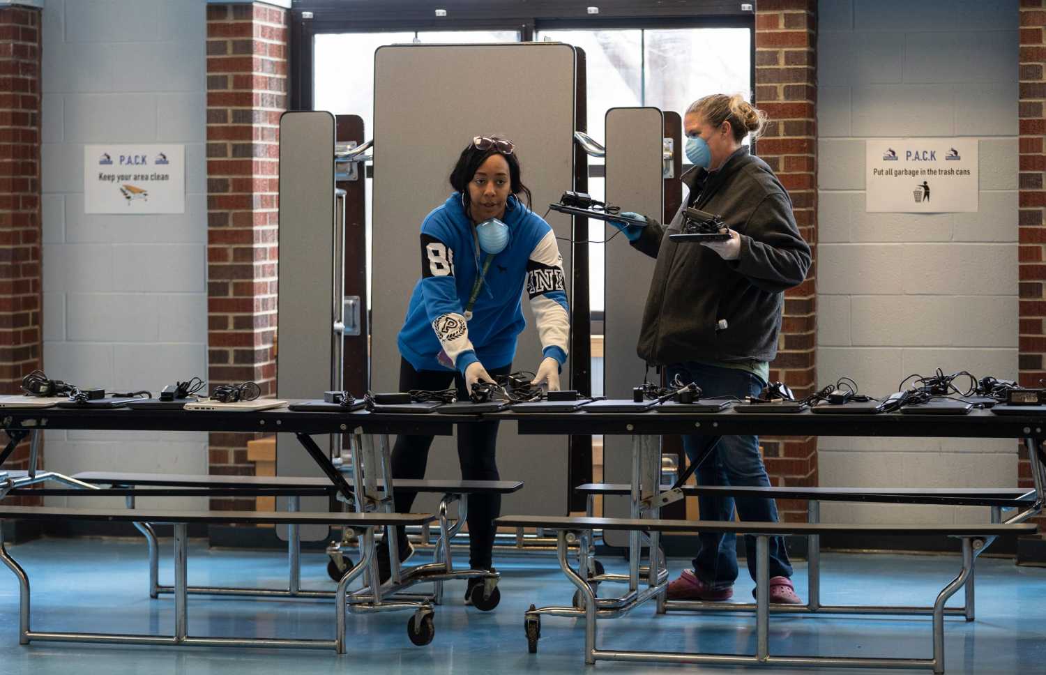 Chromebook laptops are lined up for students in West Bloomfield School District to pick up to do their work from home at Roosevelt Elementary School in Keego Harbor as the school remains closed due to COVID-19 pandemic on Monday, June 16, 2020.031620 Meal Program Rg 09