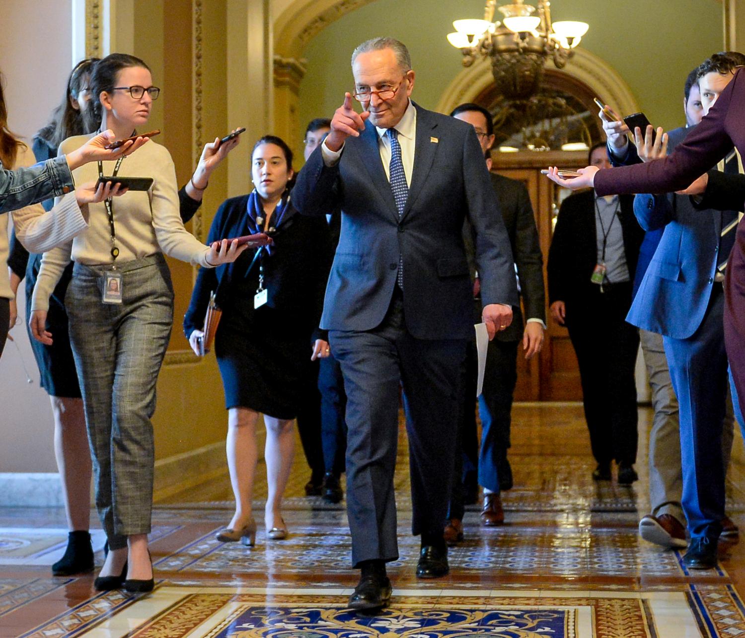 U.S. Senate Minority Leader Chuck Schumer (D-NY)  heads to a meeting in the office of U.S. Senate Majority Leader Mitch McConnell (R-KY) to wrap up work on coronavirus economic aid legislation, during the coronavirus disease (COVID-19) outbreak, in Washington, U.S., March 22, 2020.      REUTERS/Mary F. Calvert