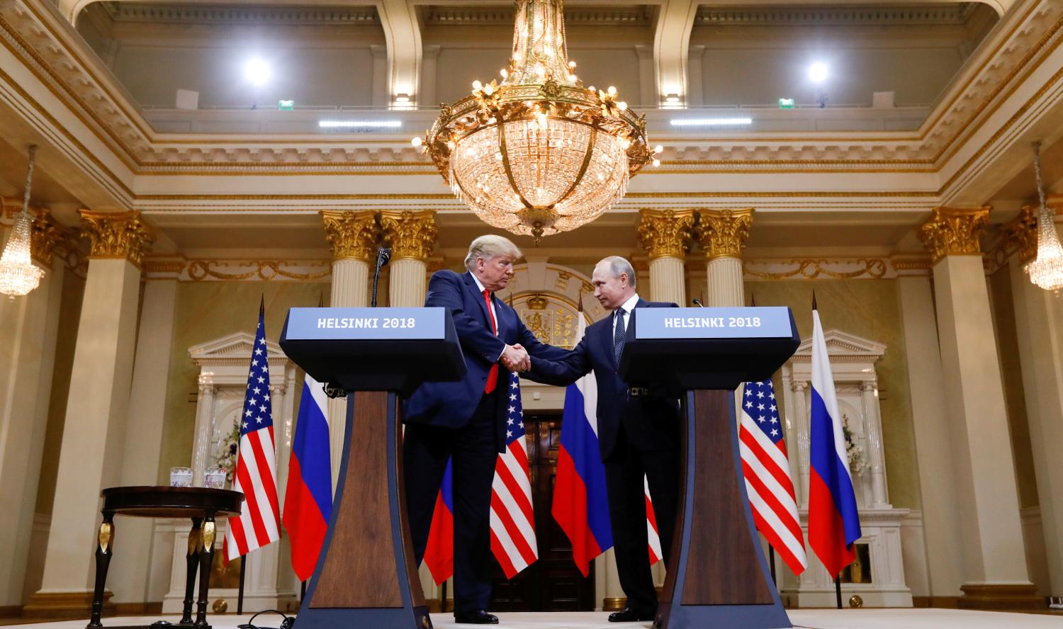 U.S. President Donald Trump and Russia's President Vladimir Putin shake hands during a joint news conference after their meeting in Helsinki, Finland, July 16, 2018. REUTERS/Kevin Lamarque     TPX IMAGES OF THE DAY