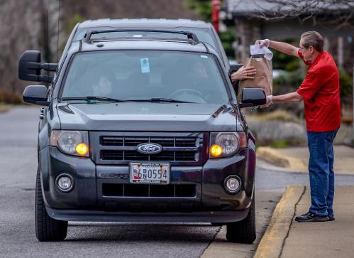 Chevy's Fresh Mex restaurant manager Stephen Justice provides curb side service because the restaurant is closed to prevent the spread of coronavirus disease (COVID-19) in Annapolis, U.S., March 18, 2020.      REUTERS/Mary F. Calvert