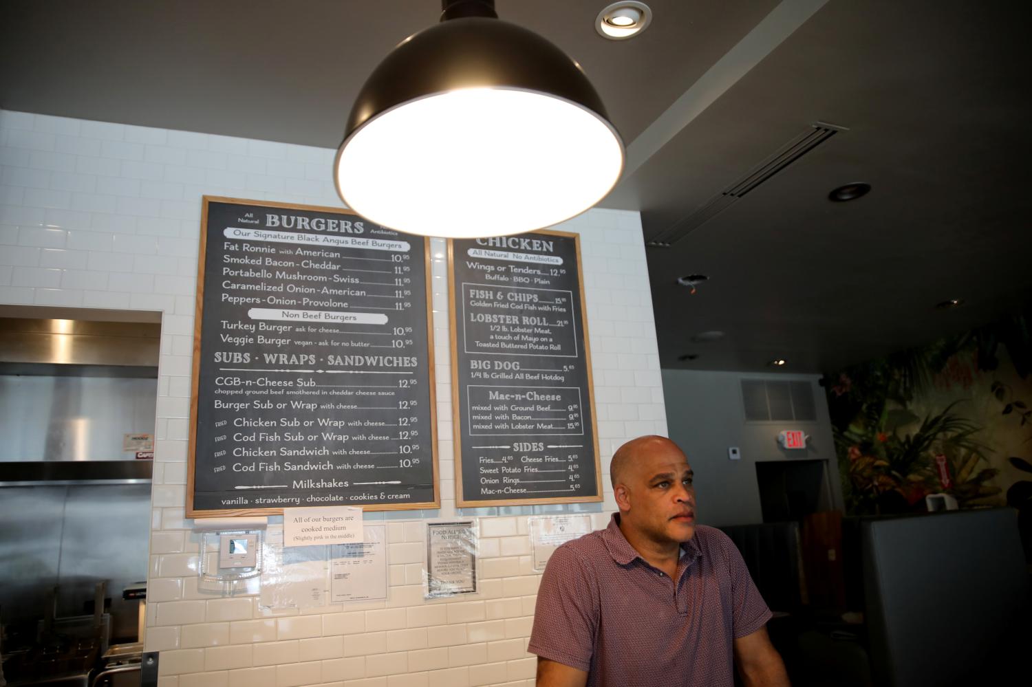 Reynaldo Faust, who opened a restaurant few weeks ago waits for costumers for takeout orders after local authorities restricted the activities of restaurants, bars, gyms, movie theaters and other similar businesses and rolled out a midnight curfew for precaution due to coronavirus disease (COVID-19) spread, in Miami Beach, Florida, U.S., March 20, 2020. REUTERS/Carlos Barria