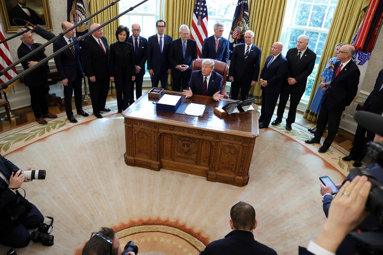 U.S. President Donald Trump signs the $2.2 trillion H.R. 748 CARES Act coronavirus aid package bill in the Oval Office of the White House in Washington, U.S., March 27, 2020. REUTERS/Jonathan Ernst     TPX IMAGES OF THE DAY
