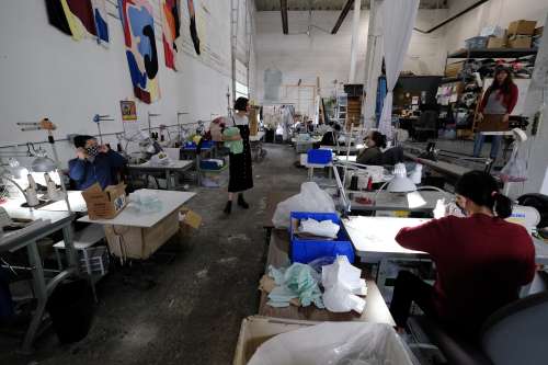 Workers make face masks at the Portland Garment Factory in Portland, Ore., on April 1, 2020. The company's owner, Britt Howard, made the decision to shift the focus of the business to fill the demand for personal protective equipment, and the studio is now producing 5,000 face masks per week with eight full-time employees. (Photo by Alex Milan Tracy/Sipa USA)No Use UK. No Use Germany.