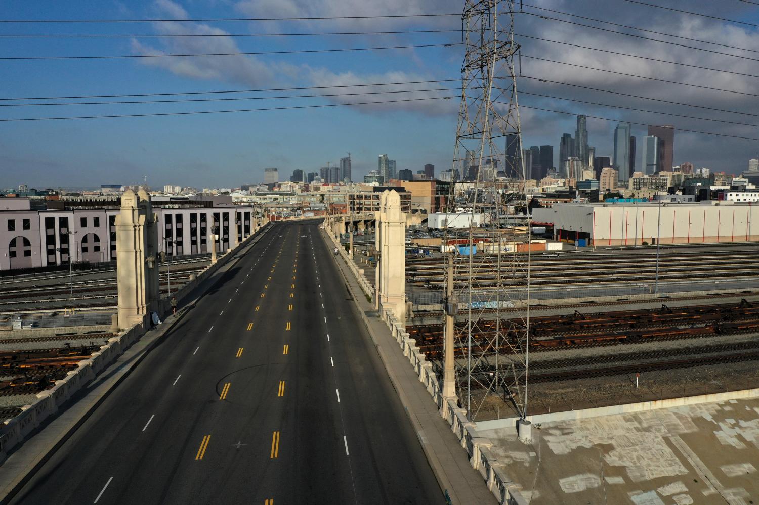 Empty freight trains sit in front of the downtown Los Angeles skyline after California issued a stay-at-home order as the spread of the coronavirus disease (COVID-19) continues, in Los Angeles, California, U.S., April 3, 2020.  REUTERS/Lucy Nicholson