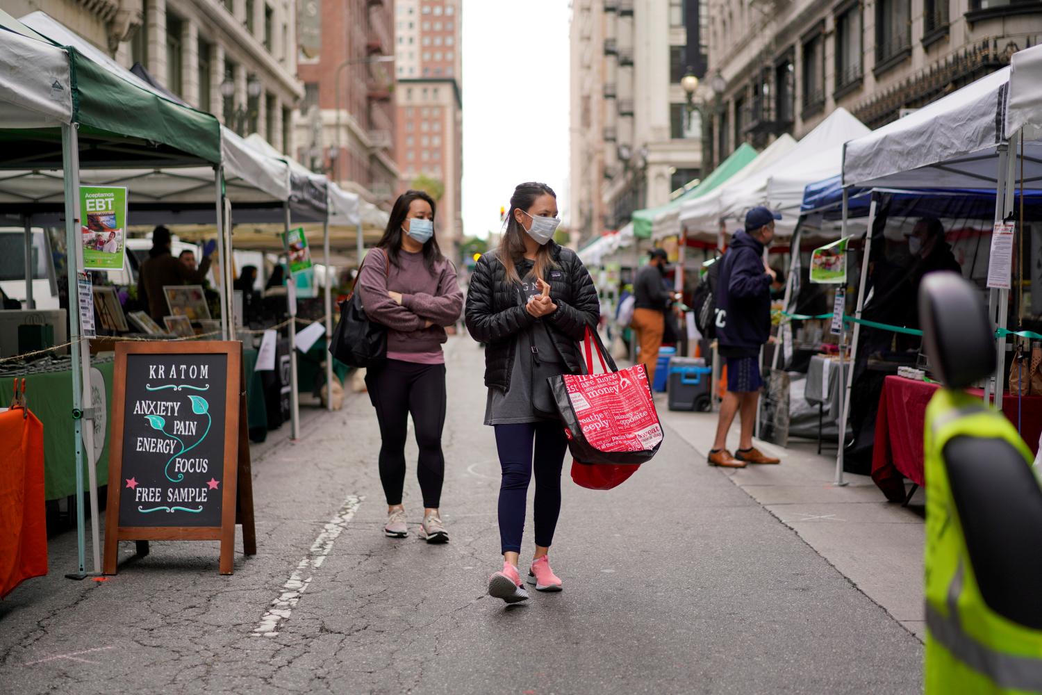 Shoppers wearing protective masks walk through the Historic Downtown Farmers Market during the outbreak of the coronavirus disease (COVID-19) in Los Angeles, California, U.S., April 5, 2020.      REUTERS/Kyle Grillot