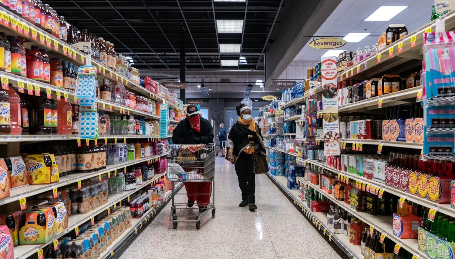 Shoppers browse in a supermarket while wearing masks to help slow the spread of coronavirus disease (COVID-19) in north St. Louis, Missouri, U.S. April 4, 2020. Picture taken April 4, 2020.  REUTERS/Lawrence Bryant