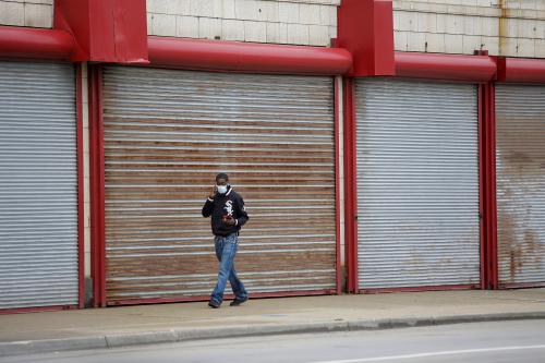 A man uses his mobile devices as he walks along 111th Street during the global outbreak of coronavirus disease (COVID-19) in Chicago, Illinois, U.S. April 7, 2020. REUTERS/Joshua Lott