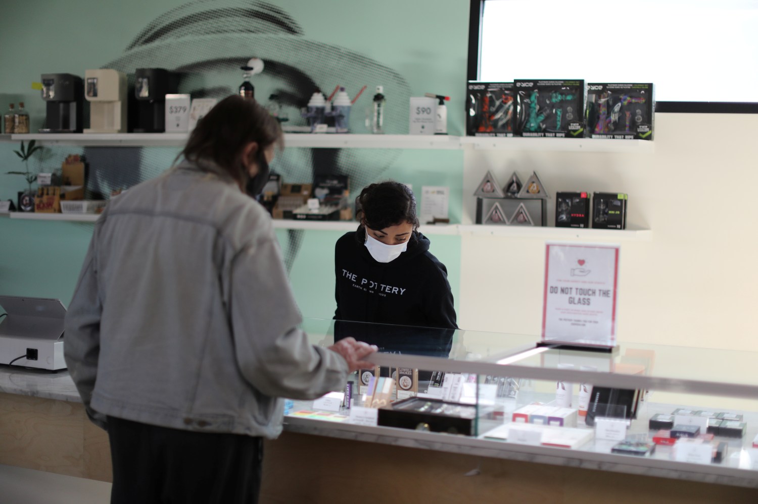 Ashlee Mason, 26, serves a customer at The Pottery Cannabis Dispensary, as marijuana deliveries increase amid the spread of the coronavirus disease (COVID-19), in Los Angeles, California, U.S., April 14, 2020.  REUTERS/Lucy Nicholson