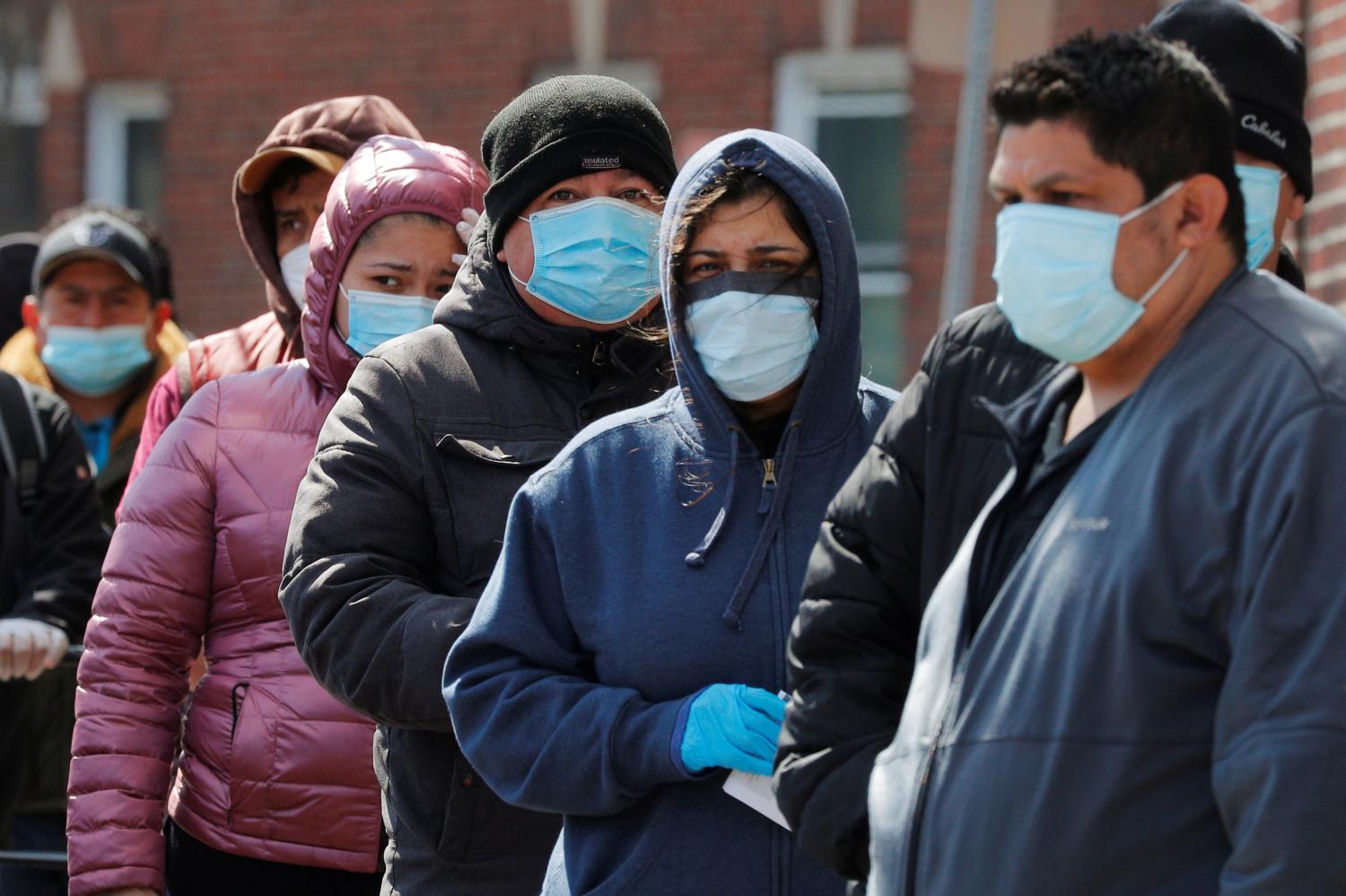 People wait in a line around the block for a pop-up food pantry amid the coronavirus disease (COVID-19) outbreak in Chelsea, Massachusetts, U.S., April 17, 2020.   REUTERS/Brian Snyder