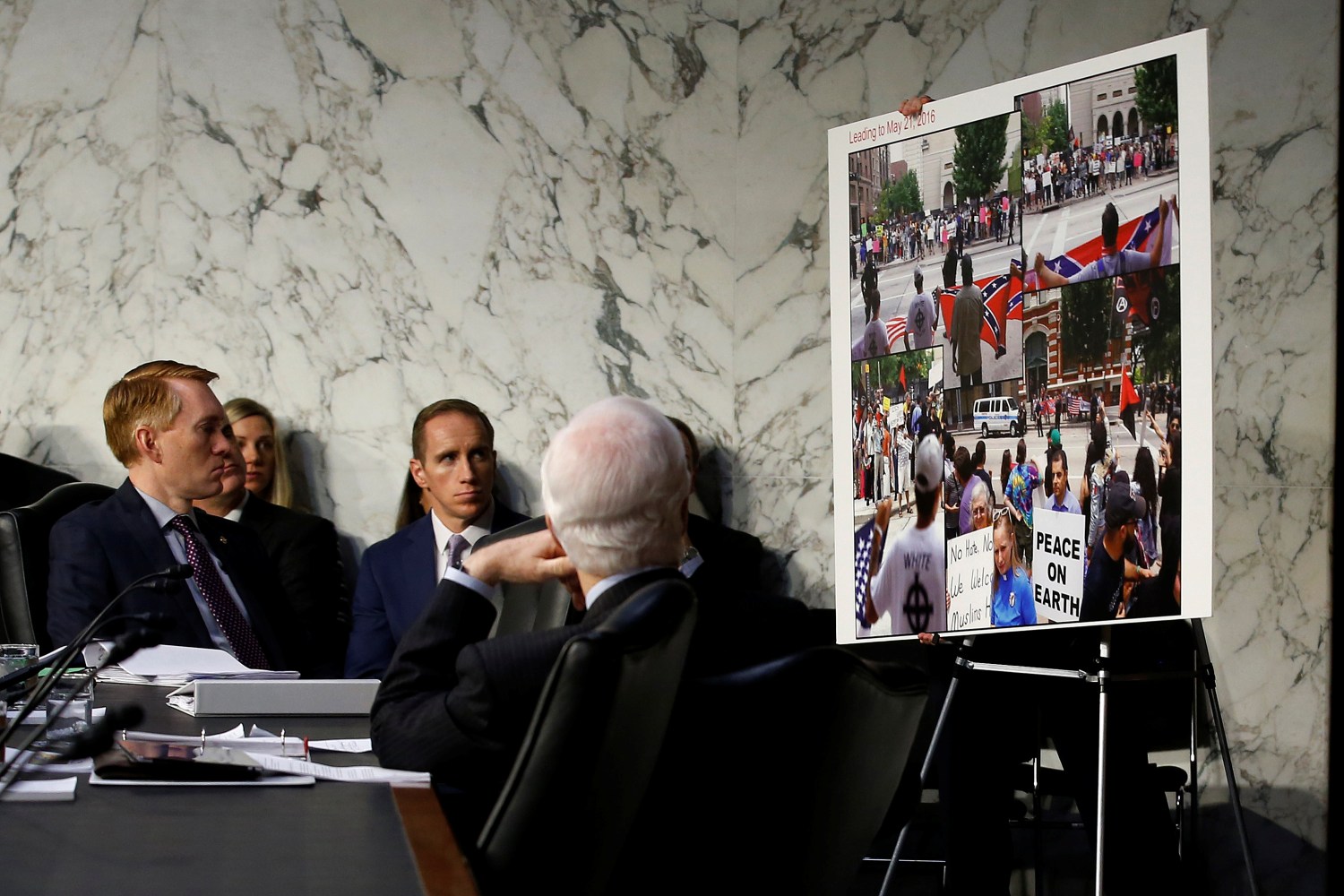 Senators look at a placard presented as evidence of Russian social media manipulation, during a Senate Intelligence Committee hearing to answer questions related to Russian use of social media to influence U.S. elections, on Capitol Hill in Washington, U.S., November 1, 2017.   REUTERS/Joshua Roberts