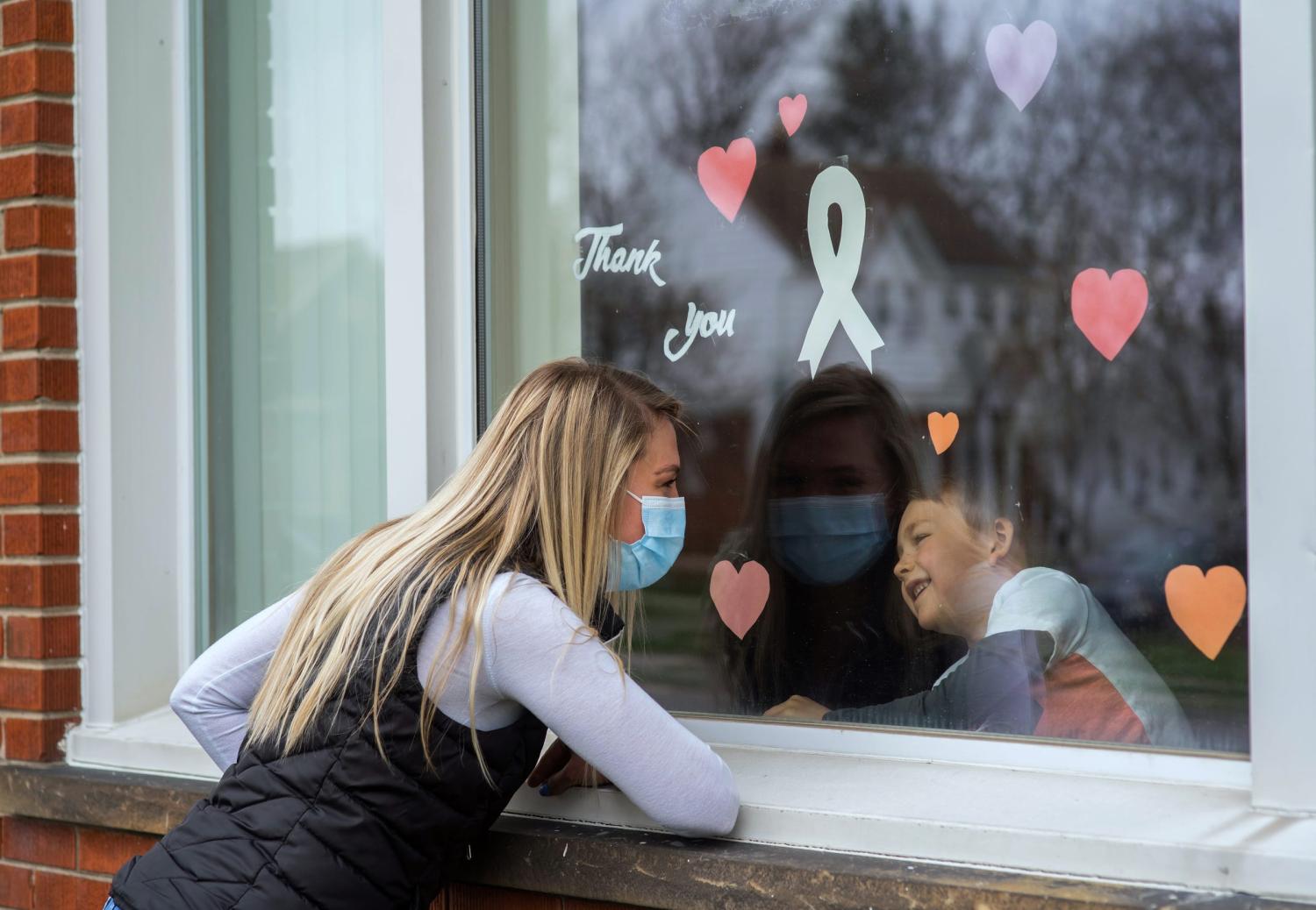 Shawn Beitler of Wyandotte visits her son Landon Beitler, who is staying at her mother's house to avoid infecting him with COVID-19, as she works as a registered nurse at Henry Ford Wyandotte Hospital and Beaumont Hospital, Dearborn. "I never thought I would have to make a decision like this. It was a hard decision but easy when I saw what happened to people," Beitler said, who took care of one of the first COVID patients at Henry Ford Wyandotte Hospital.  She stops by every day that she can to say hello to her son and family through the window. "I could never live with myself if I gave it to my parents."041520 Nurses And Housing R 2