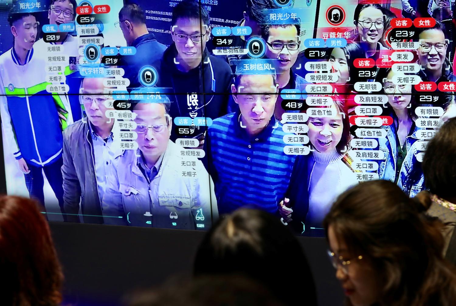 Visitors are seen at a screen displaying facial recognition technology at the Digital China Exhibition in Fuzhou, Fujian province, China May 8, 2019. China Daily via REUTERS  ATTENTION EDITORS - THIS IMAGE WAS PROVIDED BY A THIRD PARTY. CHINA OUT. NO COMMERCIAL OR EDITORIAL SALES IN CHINA. - RC155F050BE0