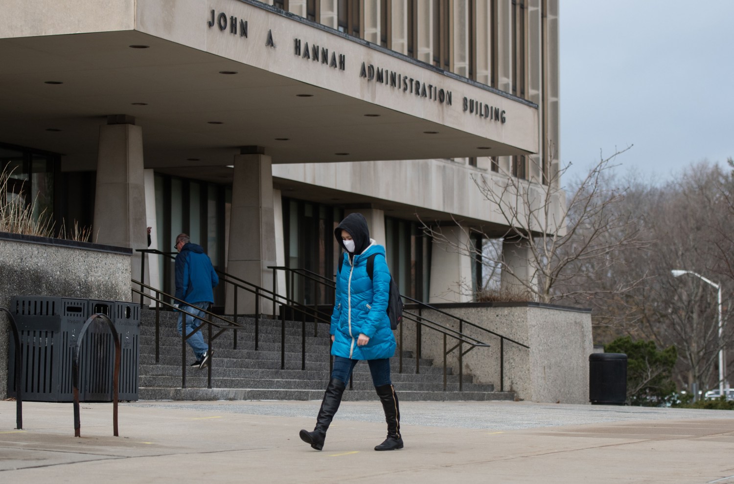 March 11, 2020; Lansing, MI , USA; Michigan State University senior Yue Yang walks past the John Hannah Administration Building Wednesday, March 11, 2020, in East Lansing, Mich.  "The president made a good decision, everyone should just be safe and pay attention," she said. The university will close person-to-person classes until April 20 and conduct classes online to minimize the potential spread of the coronavirus.  "My parents worry about me but I'll be alright." Mandatory Credit: Matthew Dae Smith/Lansing State Journal via USA TODAY NETWORK