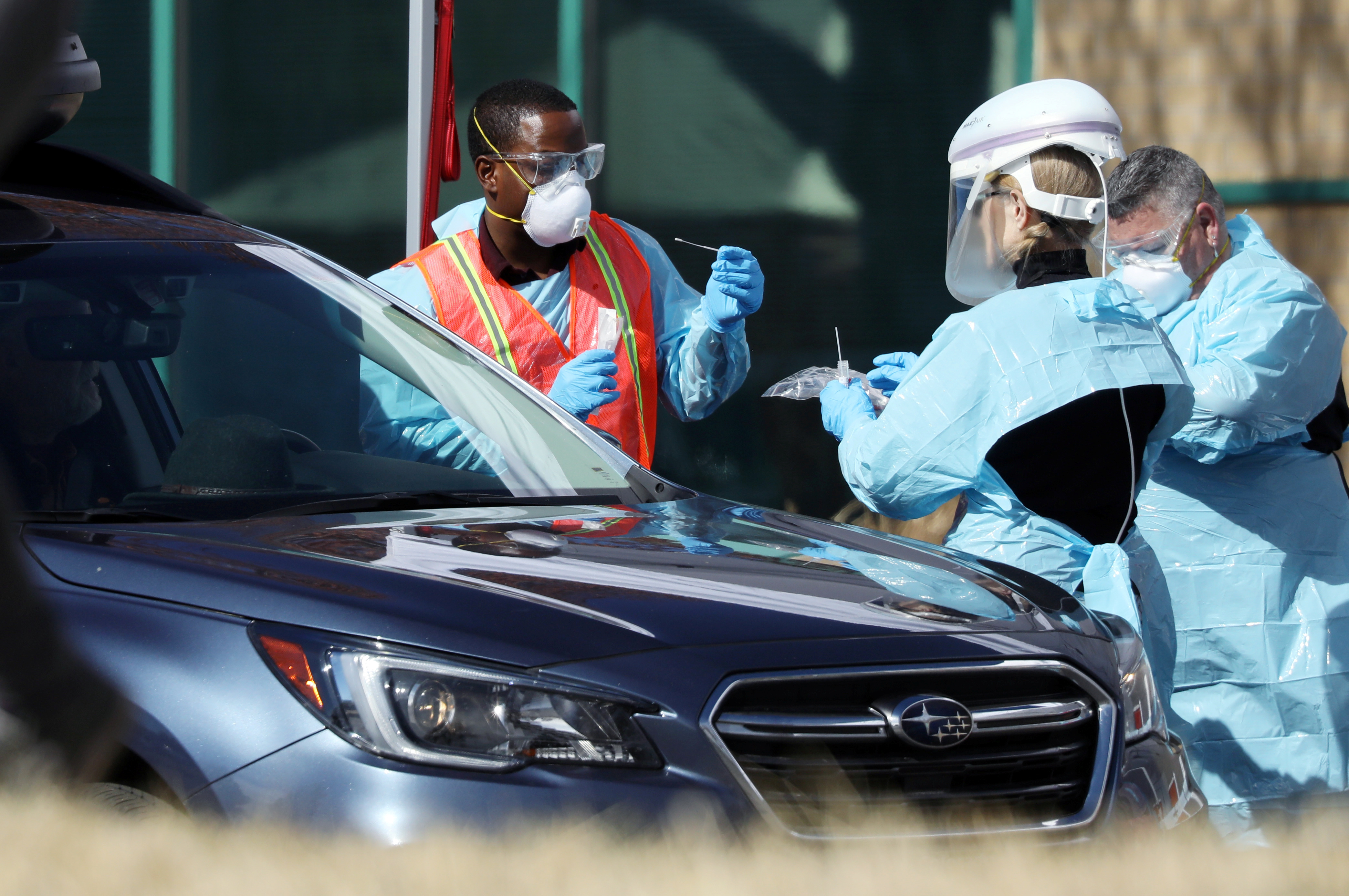 Health care workers test people at a drive-thru testing station run by the state health department, for people who suspect they have novel coronavirus, in Denver, Colorado, U.S. March 11, 2020. REUTERS/Jim Urquhart
