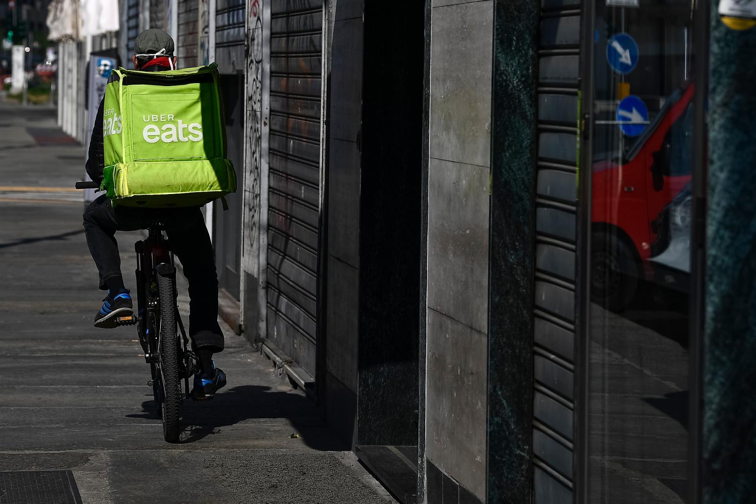 TURIN, ITALY - March 18, 2020: A Uber Eats food rider rides during his work. The Italian government imposed unprecedented restrictions to halt the spread of COVID-19 coronavirus outbreak, among other measures people movements are allowed only for work, for buying essential goods and for health reasons. Restaurants are closed to customers, only home deliveries are allowed. (Photo by Nicolò Campo/Sipa USA)No Use UK. No Use Germany.