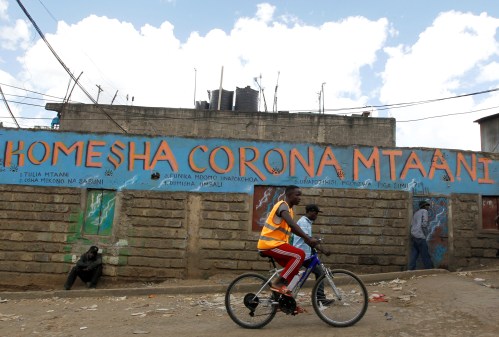 A man cycles past a wall mural advocating against the coronavirus disease (COVID-19) outbreak in Nairobi, Kenya April 11, 2020. REUTERS/Njeri Mwangi