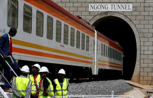 Workers are seen outside a train on the Standard Gauge Railway (SGR) line constructed by the China Road and Bridge Corporation (CRBC) and financed by Chinese government in Kimuka, Kenya October 16, 2019. REUTERS/Thomas Mukoya
