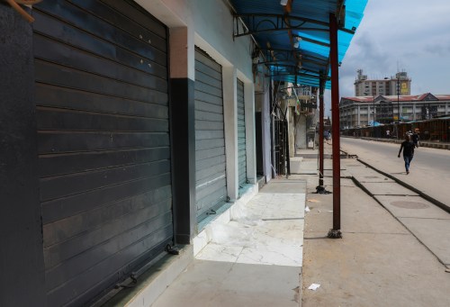 A man walks past closed shops in a nearly deserted wholesale market during lockdown by the authorities to limit the spread of coronavirus in Lagos, Nigeria, March 27, 2020. Picture taken March 27, 2020. REUTERS/Temilade Adelaja