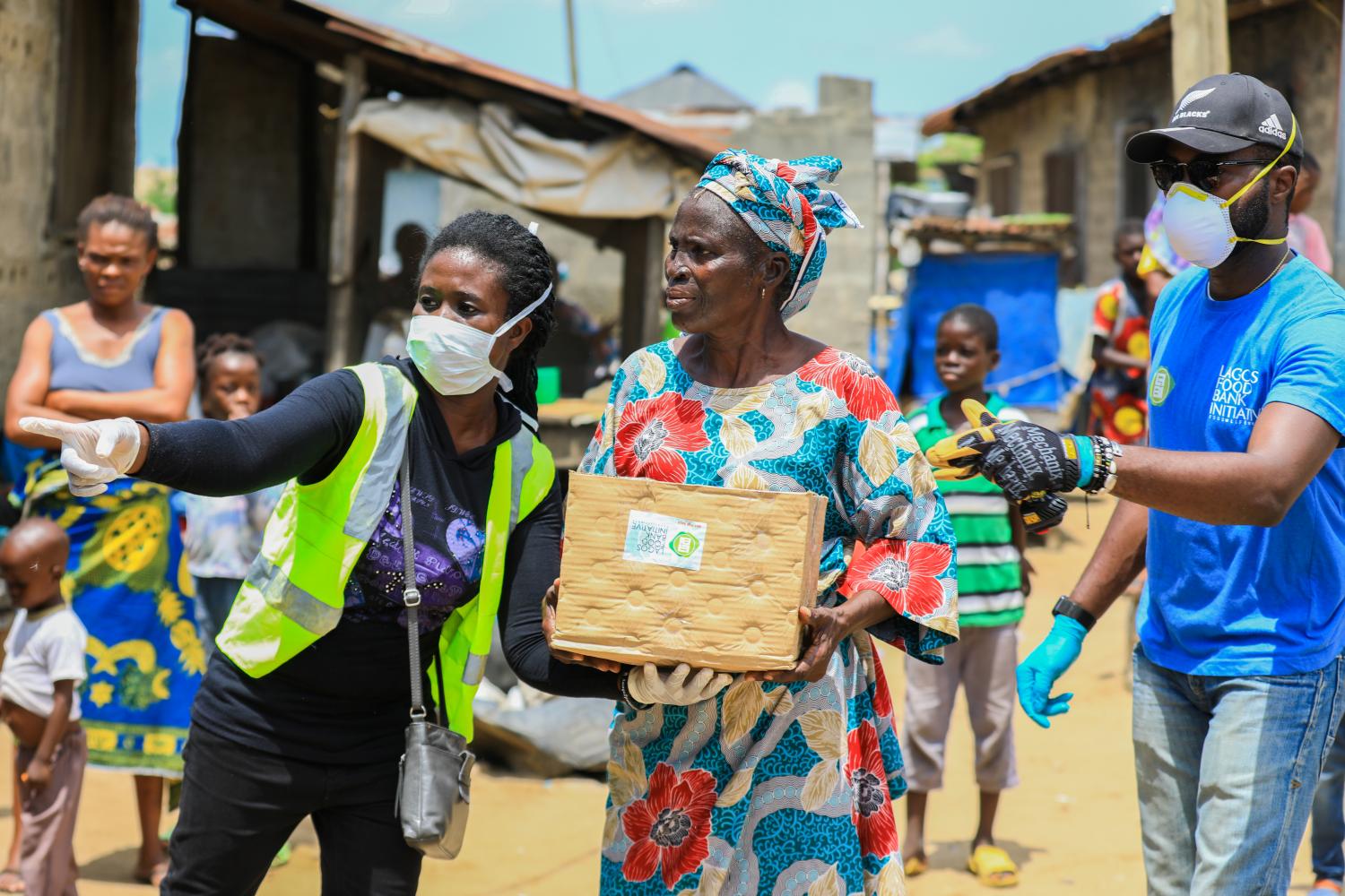 Volunteers gesture as they direct an elderly woman at an ongoing distribution of food parcels, during a lockdown by the authories in efforts to slow the spread of the coronavirus disease (COVID-19), in Lagos, Nigeria April 9, 2020. Picture taken April 9, 2020. REUTERS/Temilade Ade