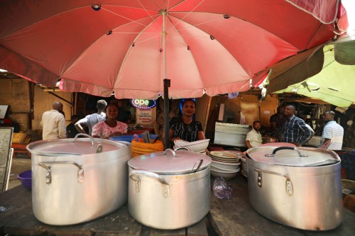 A food vendor, popularly known as a "Mama Put", arranges her sets of pots and plates on a table in Abuja, Nigeria, January 25, 2020. Picture taken January 25, 2020. REUTERS/Afolabi Sotunde