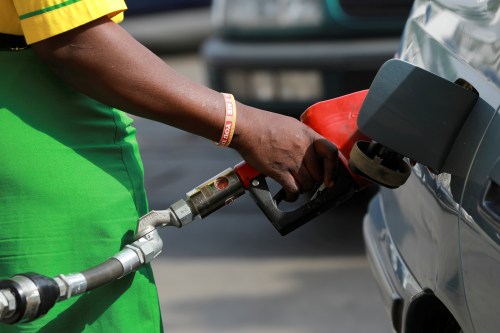 FILE PHOTO: A gas station attendant pumps fuel into a car at the NNPC Mega petrol station in Abuja, Nigeria, March 19, 2020. REUTERS/Afolabi Sotunde/File Photo