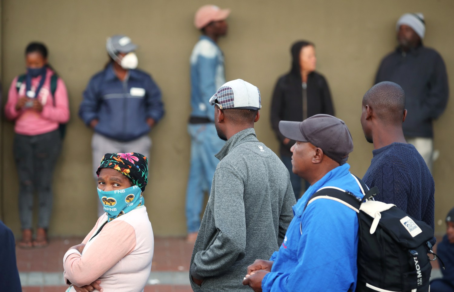 People queue to collect social grants and shop during a 21 day nationwide lockdown aimed at limiting the spread of coronavirus disease (COVID-19) in Khayelitsha township near Cape Town, South Africa, March 31, 2020. Reuters/Mike Hutchings