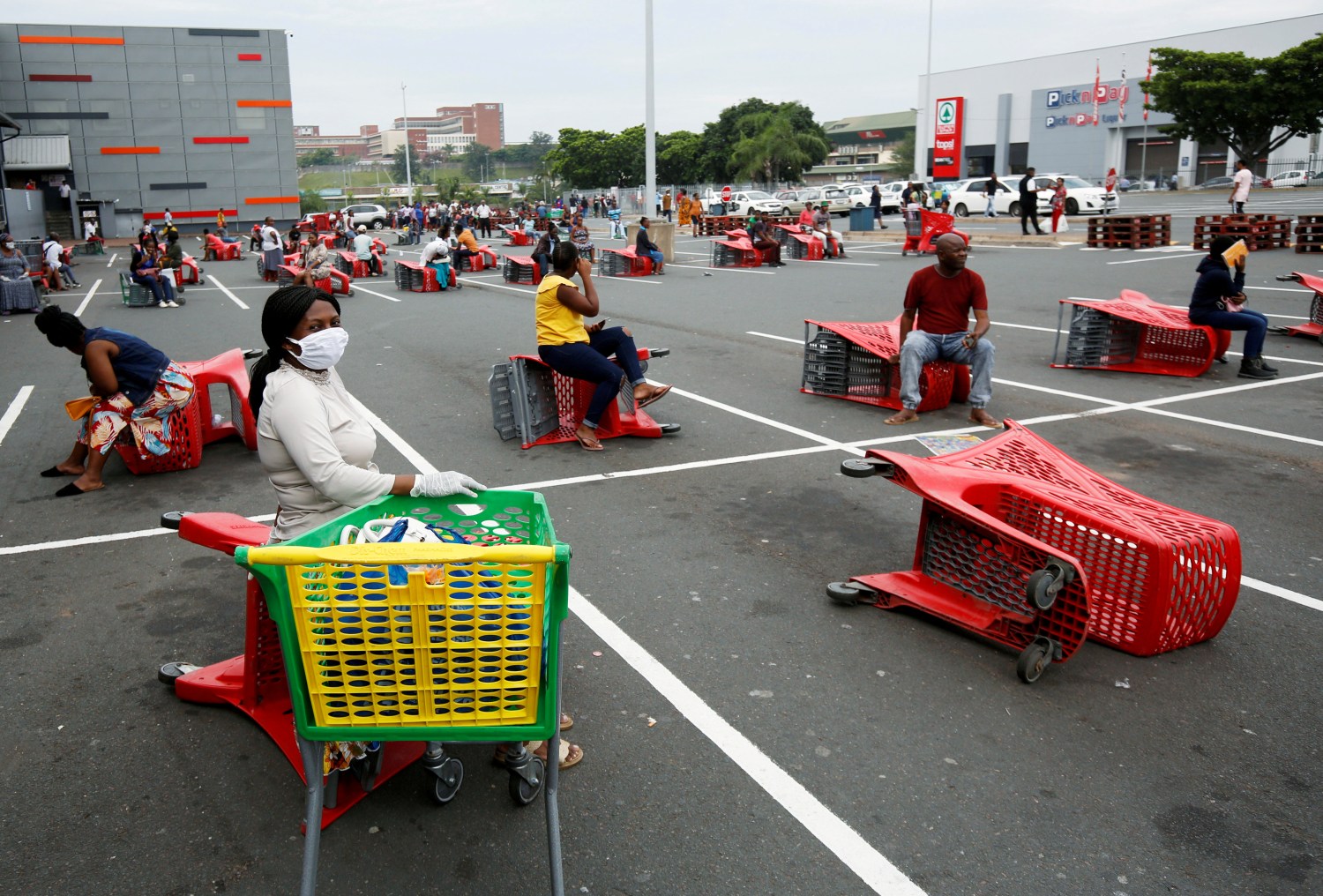 Shoppers queue at a grocery store during a nationwide 21 day lockdown in an attempt to contain the coronavirus disease (COVID-19) outbreak in Chatsworth near Durban, South Africa, March 31, 2020. REUTERS/Rogan Ward  REFILE - CORRECTING INFORMATION     TPX IMAGES OF THE DAY