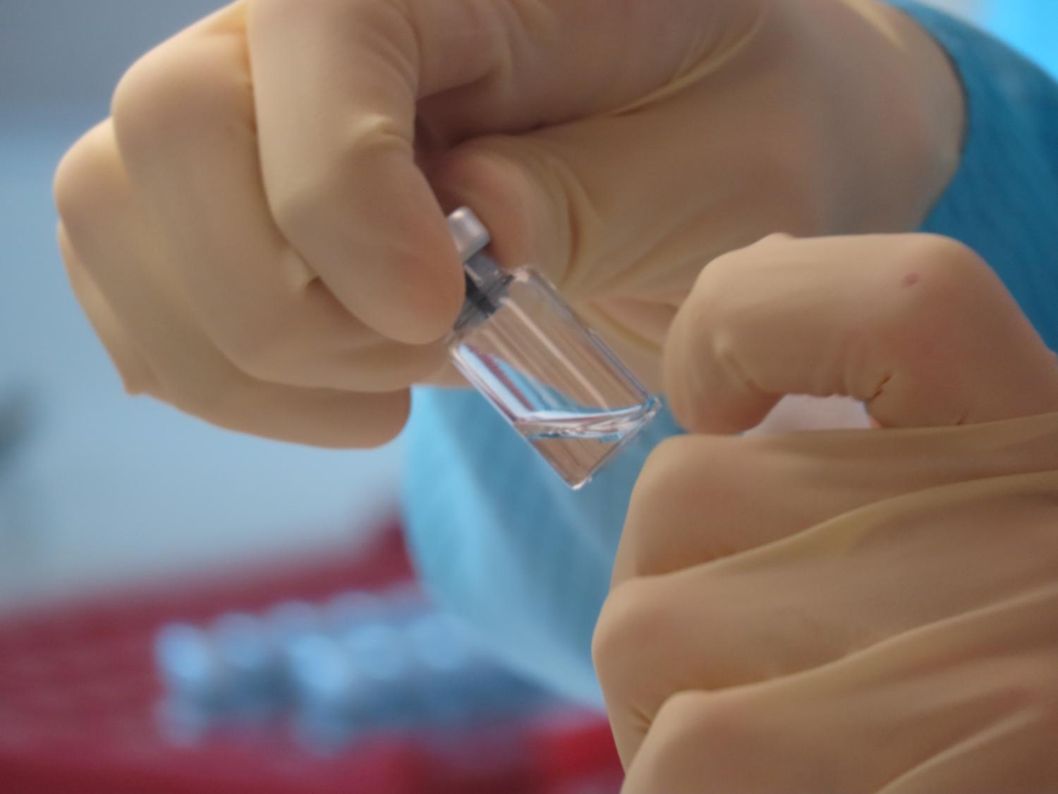 A scientist cleans vaccine vials at the Clinical Biomanufacturing Facility (CBF) in Oxford, Britain, April 2, 2020. Picture taken April 2, 2020. Sean Elias/Handout via REUTERS THIS IMAGE HAS BEEN SUPPLIED BY A THIRD PARTY. MANDATORY CREDIT. NO RESALES. NO ARCHIVES