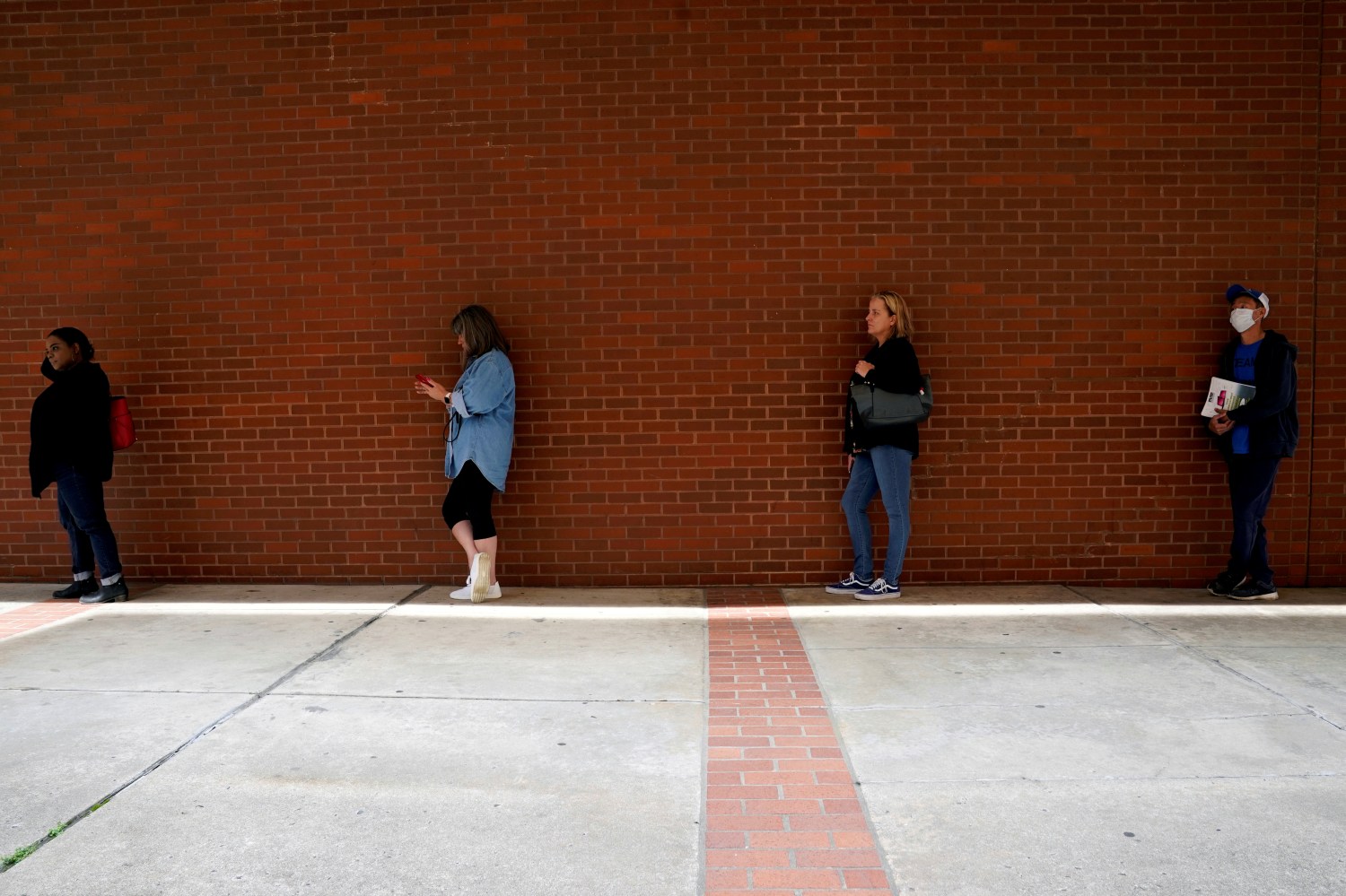 FILE PHOTO: People who lost their jobs wait in line to file for unemployment benefits, following an outbreak of the coronavirus disease (COVID-19), at Arkansas Workforce Center in Fort Smith, Arkansas, U.S. April 6, 2020. REUTERS/Nick Oxford/File Photo