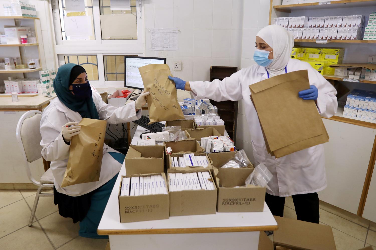 Members of the medical staff at UNRWA prepare prescription medicines to deliver to Palestinian refugees in their homes at Amman New camp (Al-Wehdat camp) amid concerns over the spread of the coronavirus disease (COVID-19), in Amman, Jordan April 15, 2020. Picture taken April 15, 2020. REUTERS/Muhammad Hamed