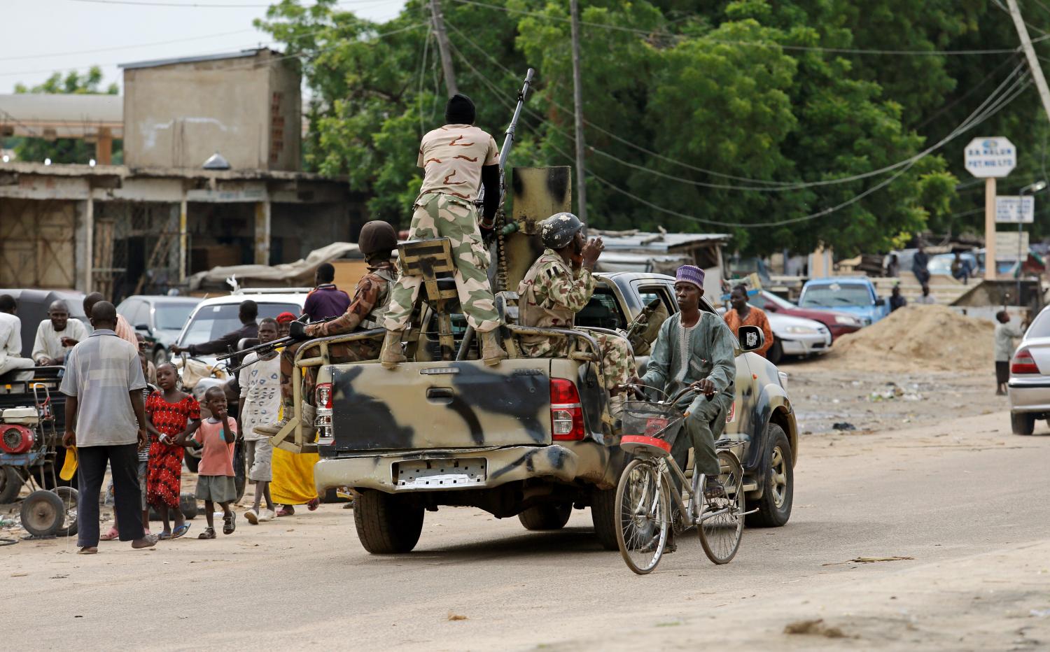 A man cycles past a military truck in Maiduguri, Borno State, Nigeria, August 31, 2016. REUTERS/Afolabi Sotunde       SEARCH "BAMA" FOR THIS STORY. SEARCH "WIDER IMAGE" FOR ALL STORIES.