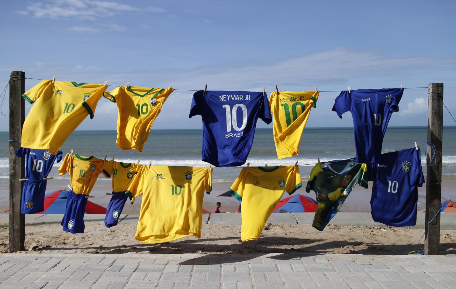 Brazilian soccer jerseys with the number ten are displayed for sale at a beach in Natal, June 20, 2014. In a project called "On The Sidelines" Reuters photographers share pictures showing their own quirky and creative view of the 2014 World Cup in Brazil.   REUTERS/Toru Hanai (BRAZIL - Tags: SPORT SOCCER WORLD CUP SOCIETY)