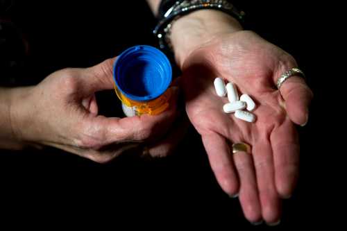 Dana Hampton, a former patient of Rinova Pain Clinics that was abandoned when her clinic in Clarksville shut down suddenly last month, holds in her hands what could be her last supply of medication at the Hampton household in Cerulean, KY., on Monday, June 3, 2019. With a dwindling supply of pain medication and no way to access her medical records, getting a new pain doctor will be challenging. "We're tired of having to start over," Hampton said about being stuck needing to get new doctors. "This isn't about opioid abusers," she said. "It's about patients abandoned by doctors." Hampton said she may need to start rationing the supply while she and her husband look for a new doctor. Hpt Dana Hampton Rinova Clinic 03