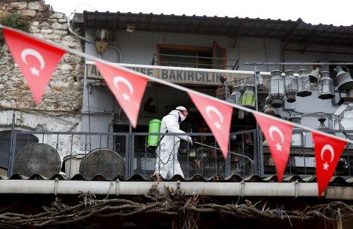 FILE PHOTO: A worker in a protective suit sprays disinfectant at Grand Bazaar, known as the Covered Bazaar, to prevent the spread of coronavirus disease (COVID-19), in Istanbul, Turkey, March 25, 2020. REUTERS/Umit Bektas/File Photo