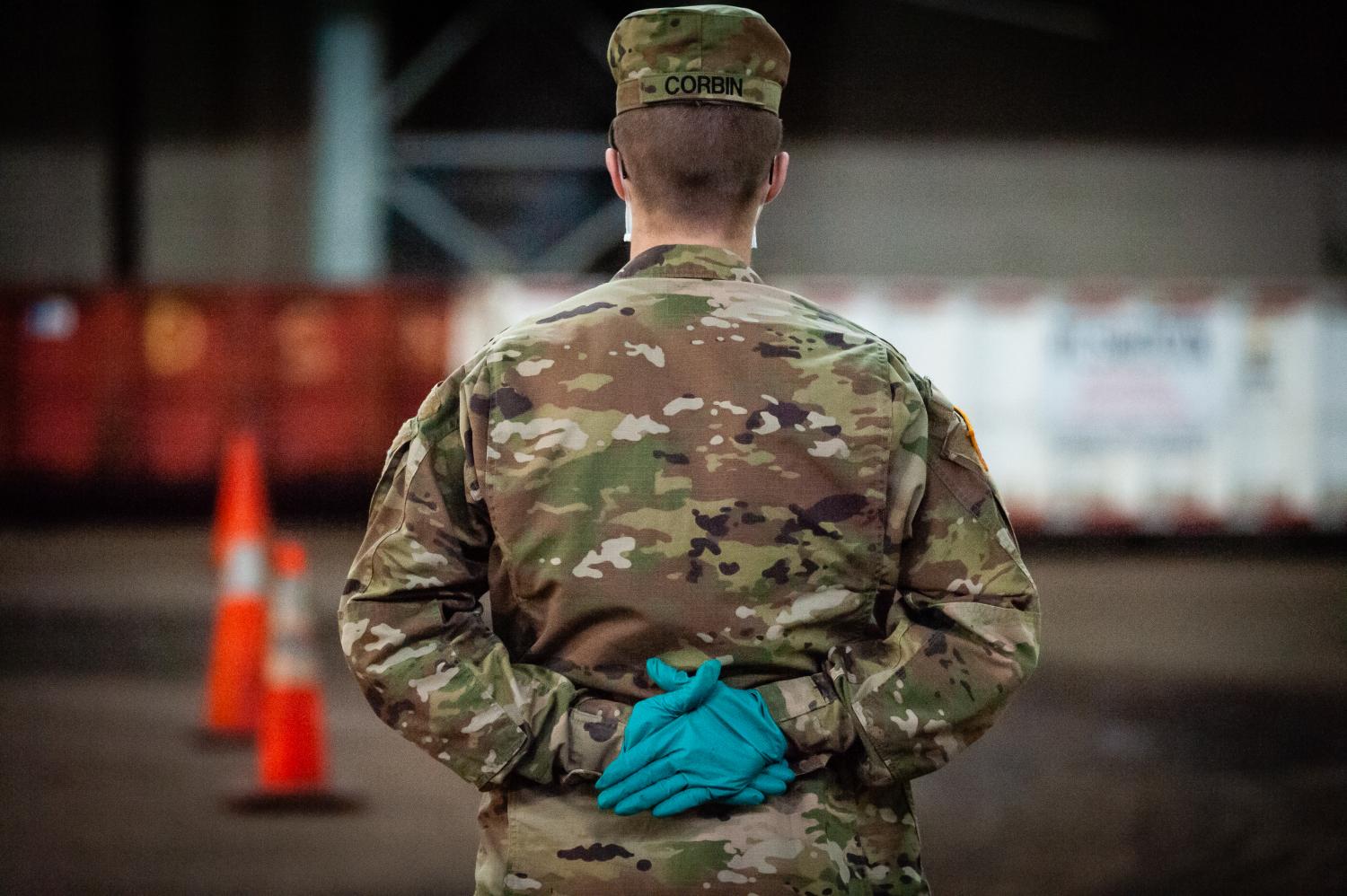 A soldier of the U.S. Army waits for the next cab driver at the Kingsbridge Armory in the Bronx on April 18, 2020.  The armory is used as a temporary food distribution center during the COVID-19 crisis and soldiers of the U.S. Army load meals into the cabs of TLC licensed drivers who deliver them to New Yorkers in need during the COVID-19 pandemic. (Photo by Gabriele Holtermann-Gorden/Sipa USA)No Use UK. No Use Germany.