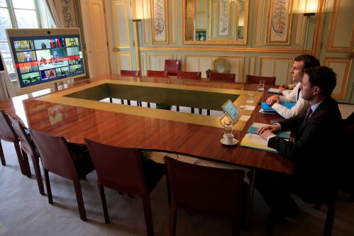 French President Emmanuel Macron and EU adviser Clement Beaune attend a videoconference at the Elysee Palace, in Paris, France March 10, 2020. Michel Euler/Pool via REUTERS