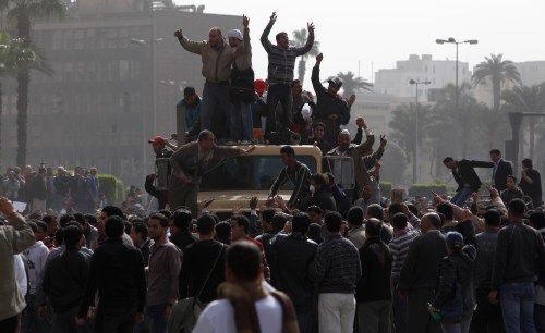 Protesters stand atop a vehicle during demonstrations in Cairo January 29, 2011. Thousands of angry Egyptians rallied in central Cairo on Saturday to demand that President Hosni Mubarak resign, dismissing his offer of dialogue and calling on troops to come over to their side.  REUTERS/Asmaa Waguih  (EGYPT - Tags: CIVIL UNREST POLITICS)