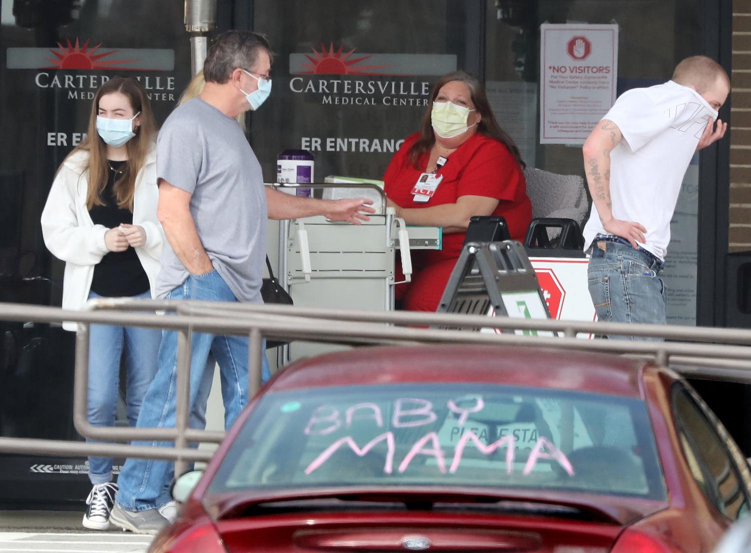 Visitors leave the screening station for coronavirus in front of the emergency department entrance at Cartersville Medical Center required for hospital entry on Tuesday, March 17, 2020, in Cartersville, Ga., where several patients have been confirmed to have COVID-19 and dozens of others are under investigation who are suspected to potentially have the coronavirus. Two triage tents have been set up for anyone who has symptoms. (Curtis Compton/Atlanta Journal-Constitution/TNS)