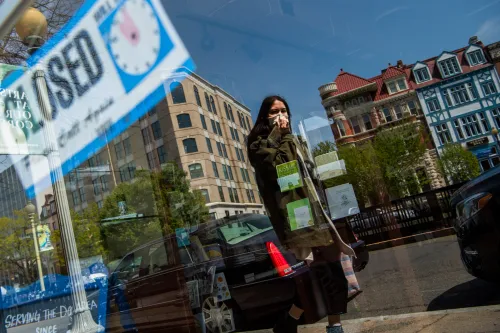 UNITED STATES - APRIL 17: A woman walks by the closed storefront of Copenhaver stationery store during the coronavirus outbreak on Connecticut Avenue in Dupont Circle on Friday, April 17, 2020. (Photo By Tom Williams/CQ Roll Call/Sipa USA)No Use UK. No Use Germany.