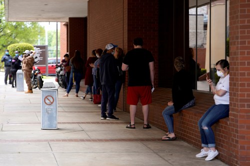FILE PHOTO: People who lost their jobs wait in line to file for unemployment following an outbreak of the coronavirus disease (COVID-19), at an Arkansas Workforce Center in Fort Smith, Arkansas, U.S. April 6, 2020. REUTERS/Nick Oxford/File Photo/File Photo