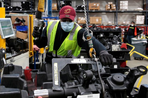Dana Inc. assembly technician Brandon Green wears a face mask as he works to assemble axles for automakers, as the auto industry begins reopening amid the coronavirus disease (COVID-19) outbreak, at the Dana plant in Toledo, Ohio,U.S., May 18, 2020. REUTERS/Rebecca Cook