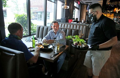 DJ Darcello is the first to order food at Tap42 Doral at City Place after the coronavirus closed the restaurant industry and other businesses, May 18, 2020. Today is the first day restaurants could open at 50 percent capacity. Photo by Charles Trainor Jr./Miami Herald/TNS/ABACAPRESS.COM