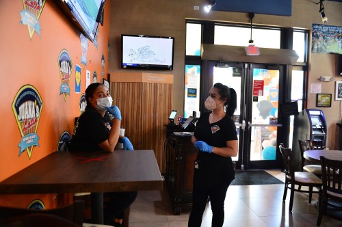 Staff of Juana's Latin Sports Bar & Grill waiting for customer to arrived for re-opens for indoor dining on May 18, 2020 in Miramar, Florida. The six year old family own restaurant with 30 plus employee re-opened approximately two months after shutting it's doors due to the coronavirus pandemic and lost over $300,000 of revenue during that time. Juana's Latin Sports Bar & Grill just received a PPP loan approval on May 6 and looking for most of they employee to come back to work. as Broward County starts the first phase of the states coronavirus pandemic re-opening plan, which includes openings with certain restrictions of businesses like barber shops, hair salon, restaurants and retail stores. (Photo by JL/Sipa USA)No Use UK. No Use Germany.