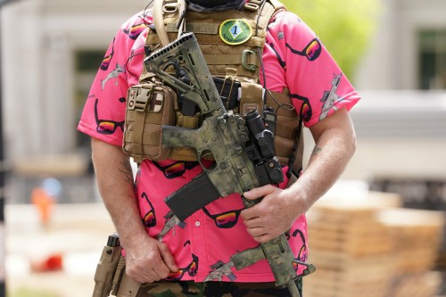 An armed demonstrator gathers for a protest against Delaware Governor John Carney?s use of the National Guard in contact tracing during the coronavirus disease (COVID-19) pandemic in Wilmington, Delaware, U.S., May 21, 2020. REUTERS/Kevin Lamarque
