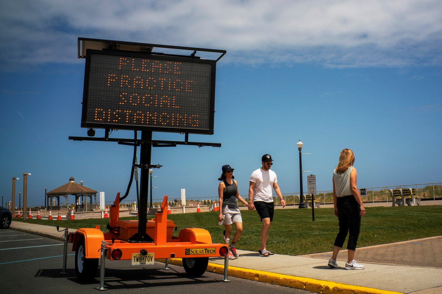 People walk near the Belmar beach on the first day that New Jersey beaches were opened ahead of the Memorial Day weekend following the outbreak of the coronavirus disease (COVID-19) in Belmar, New Jersey, U.S., May 22, 2020. REUTERS/Eduardo Munoz