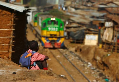A child watches a train passing through the Kibera slum of Kenya's capital Nairobi February 26, 2015.REUTERS/Darrin Zammit Lupi (KENYA - Tags: SOCIETY TRANSPORT)