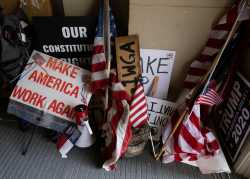 Protesters leave their flags and signs at the entrance of the state capitol building after protesters occupied the building during a vote to approve the extension of Governor Gretchen Whitmer's emergency declaration/stay-at-home order due to the coronavirus disease (COVID-19) outbreak, at the state capitol in Lansing, Michigan, U.S. April 30, 2020.  REUTERS/Seth Herald