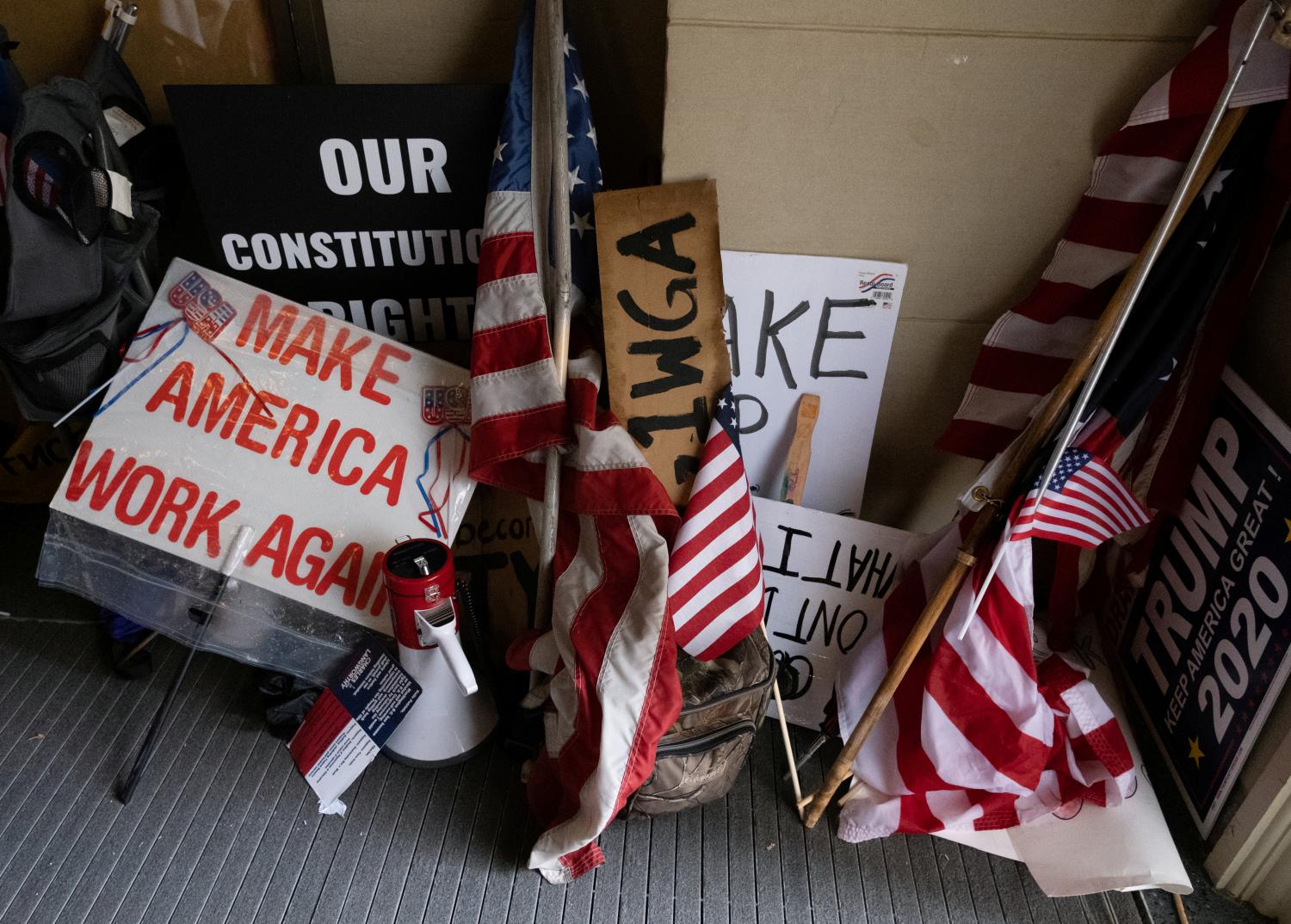 Protesters leave their flags and signs at the entrance of the state capitol building after protesters occupied the building during a vote to approve the extension of Governor Gretchen Whitmer's emergency declaration/stay-at-home order due to the coronavirus disease (COVID-19) outbreak, at the state capitol in Lansing, Michigan, U.S. April 30, 2020.  REUTERS/Seth Herald