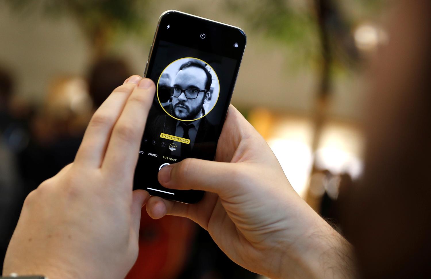 A customer uses the new face-recognition software on the new iPhone X inside the Apple Store in Regents Street in London, Britain, November 3, 2017. REUTERS/Peter Nicholls